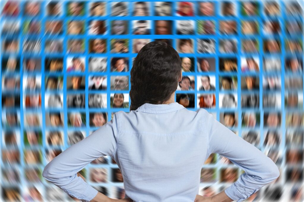 Digital growth partner, Woman from behind looking at a curved grid of diverse profile photos